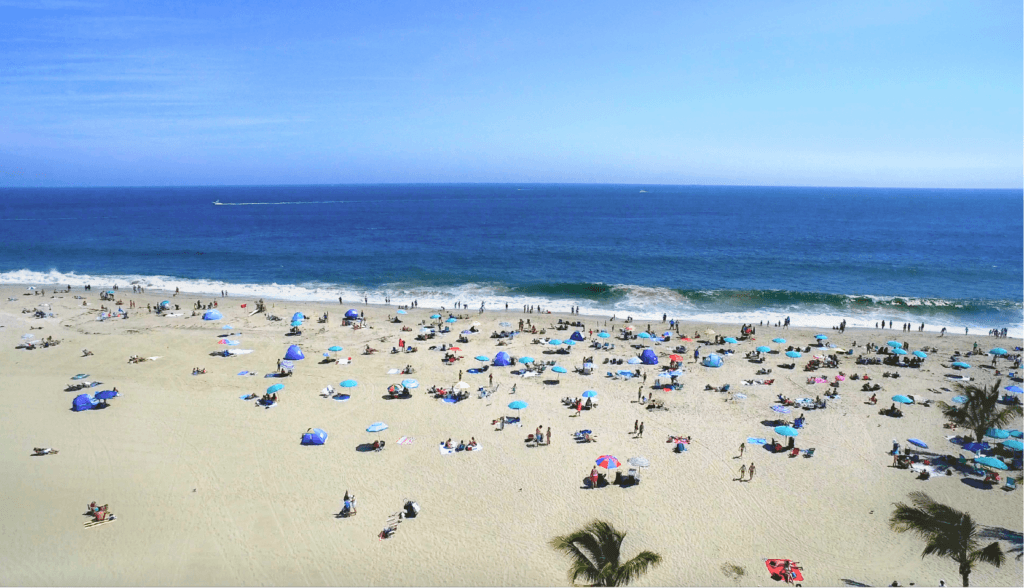 An aerial shot of people laying on Jenkinson's Beach.