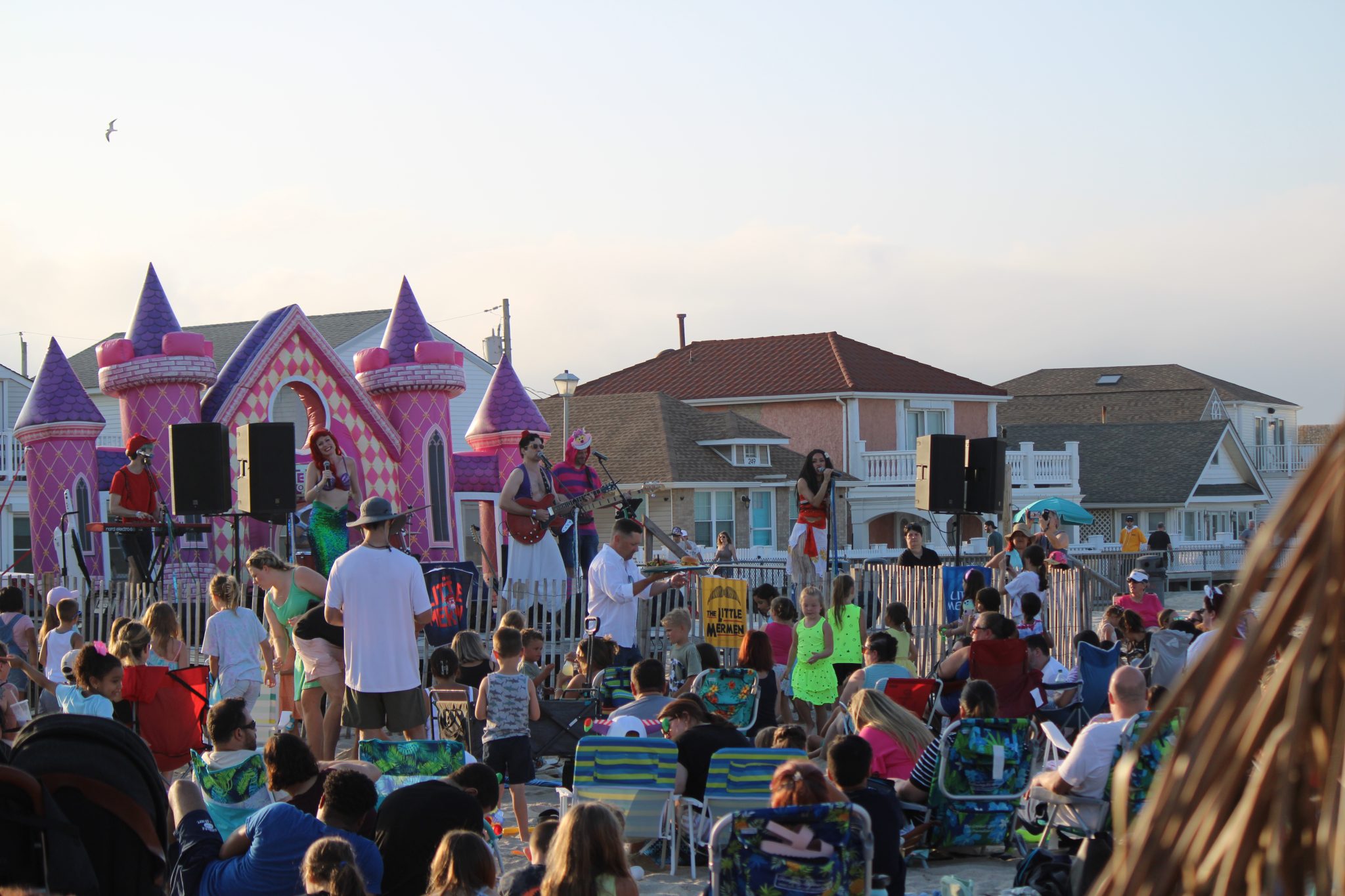 A diverse group of individuals sitting on chairs, engaged in conversation and listening attentively.