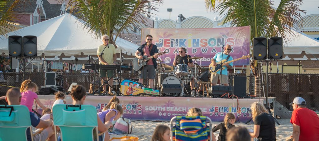 A crowd watching a concert on the beach
