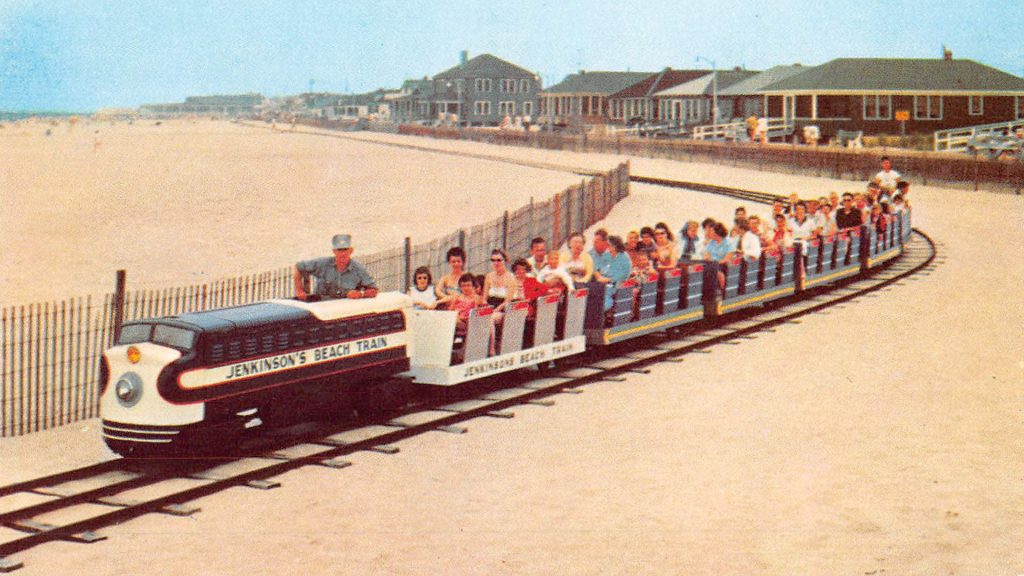 Vintage photo of the Jenkinson’s Boardwalk train ride traveling along the beach with families onboard.