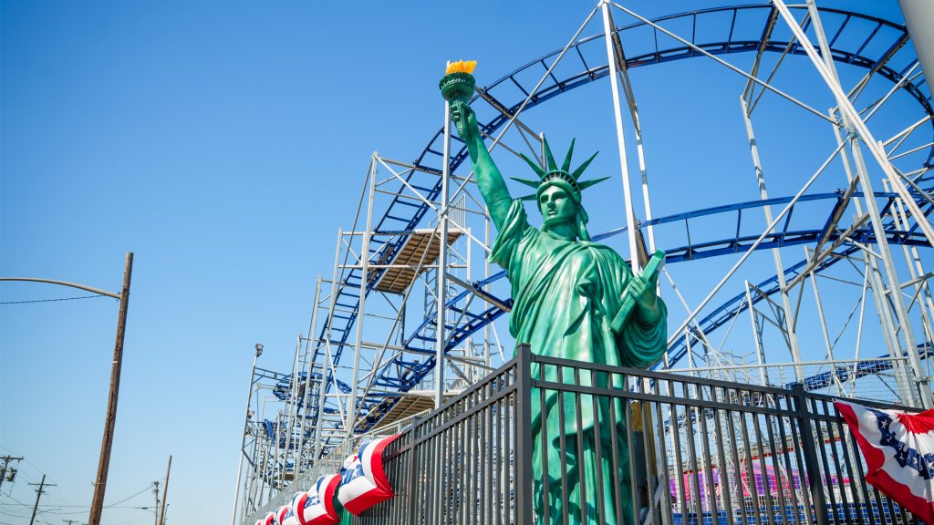 Statue of Liberty display in front of a roller coaster at Jenkinson’s Boardwalk amusement park in Point Pleasant Beach, NJ.